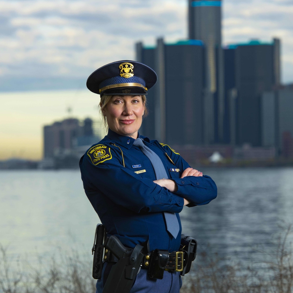 Photo of Inspector Sarah Krebs with the Detroit skyline in the background