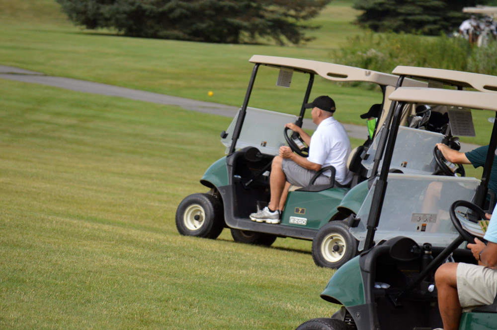 Photo of Chris Melde Driving a Golf Cart